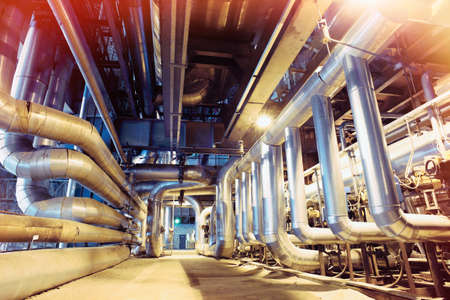 Equipment, cables and piping as found inside of a modern industrial power plant       