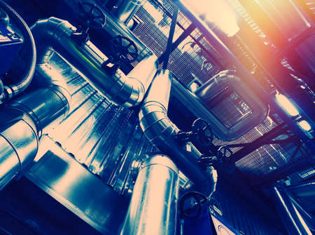 Equipment, cables and piping as found inside of a modern industrial power plant
