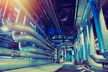 different size and shaped pipes and valves at a power plantの写真素材