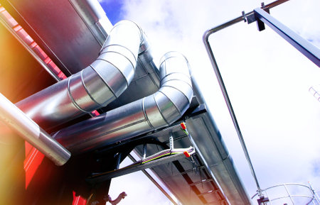 Industrial zone, Steel pipelines and valves against blue sky