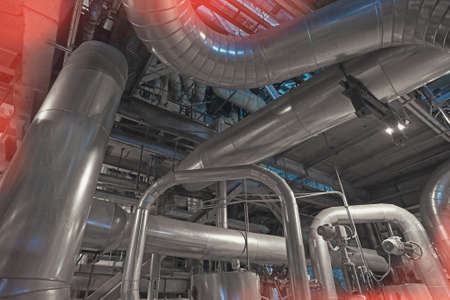 Equipment, cables and piping as found inside of a modern industrial power plant