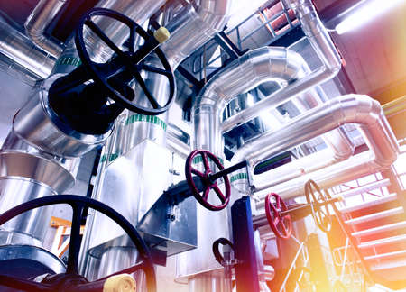 Equipment, cables and piping as found inside of a modern industrial power plant