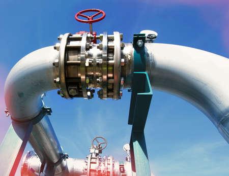 Industrial zone, Steel pipelines and valves against blue skyの写真素材