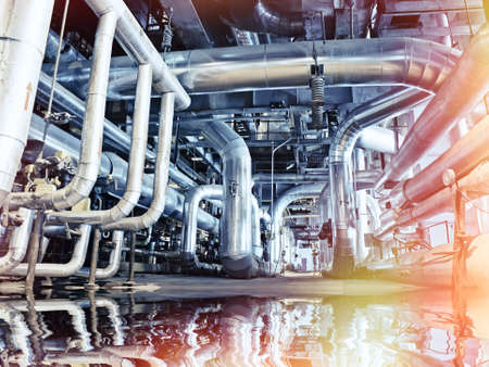 Equipment, cables and piping as found inside of a modern industrial power plant