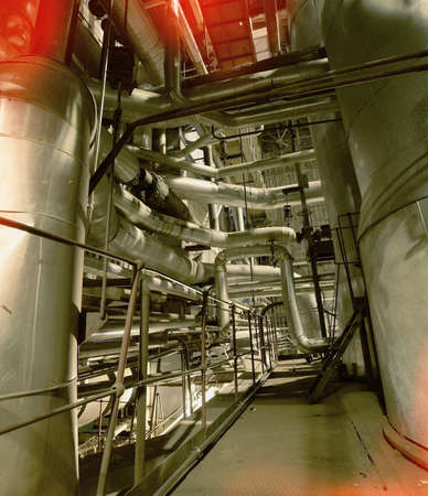 Equipment, cables and piping as found inside of a modern industrial power plant