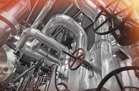 equipment, cables and piping as found inside of a modern industrial power plant