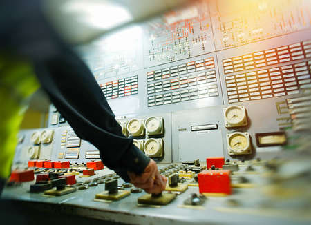 Hand on the control panel of a power plantの写真素材