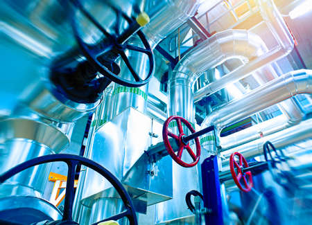 Industrial Factory. Various mechanisms and metal pipes. Toned image. Motion blur effect.
