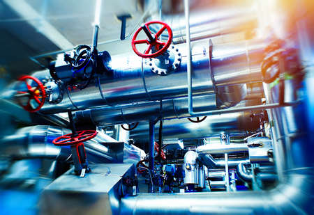Industrial Factory. Various mechanisms and metal pipes. Toned image. Motion blur effect.