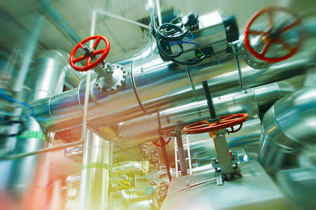 Industrial Factory. Various mechanisms and metal pipes. Toned image. Motion blur effect.