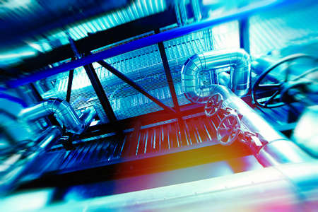 Industrial Factory. Various mechanisms and metal pipes. Toned image. Motion blur effect.の写真素材
