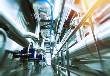 Industrial Factory. Various mechanisms and metal pipes. Toned image. Motion blur effect.の写真素材