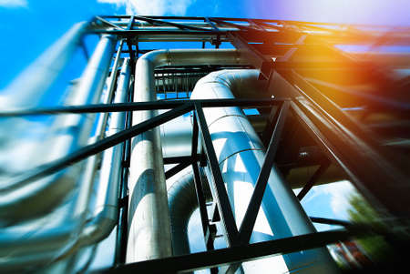 Industrial Factory. Various mechanisms and metal pipes. Toned image. Motion blur effect.