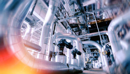 Industrial Factory. Various mechanisms and metal pipes. Toned image. Motion blur effect.