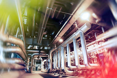 Industrial Factory. Various mechanisms and metal pipes. Toned image. Motion blur effect.             の写真素材
