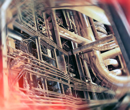 Industrial Factory. Various mechanisms and metal pipes. Toned image. Motion blur effect.の写真素材