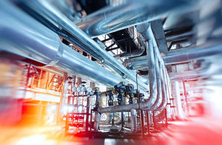 Industrial Factory. Various mechanisms and metal pipes. Toned image. Motion blur effect.の写真素材