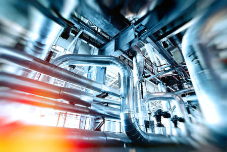 Industrial Factory. Various mechanisms and metal pipes. Toned image. Motion blur effect.の写真素材