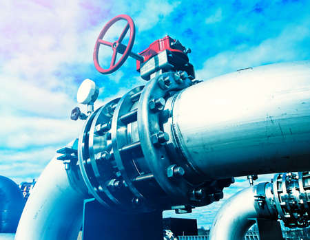Industrial zone, Steel pipelines and valves against blue skyの写真素材