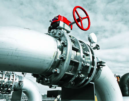 Industrial zone, Steel pipelines and valves against blue sky