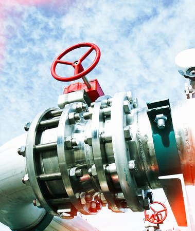 Industrial zone, Steel pipelines and valves against blue sky