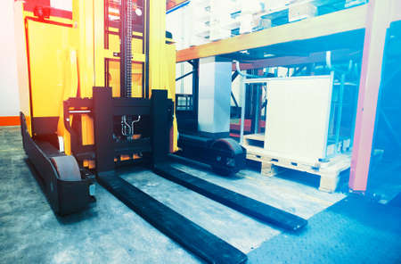 Shelves, racks and forklift  with pallets in distribution warehouse interiorの写真素材