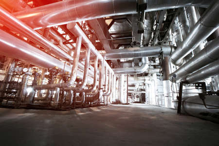 Equipment, cables and piping as found inside of a modern industrial power plant