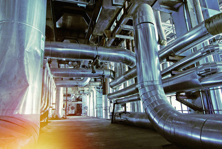 Equipment, cables and piping as found inside of a industrial power plant