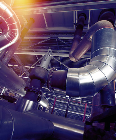 Equipment, cables and piping as found inside of a industrial power plant