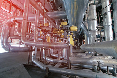 Equipment, cables and piping as found inside of a modern industrial power plant
