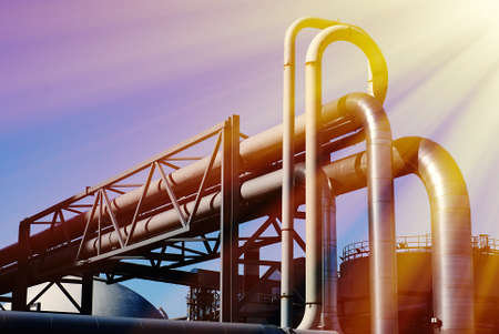 industrial pipelines on pipe-bridge against blue skyの写真素材