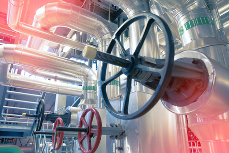 Equipment, cables and piping as found inside of a modern industrial power plant