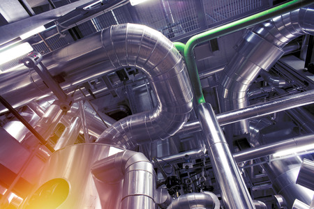 Equipment, cables and piping as found inside of a modern industrial power plant