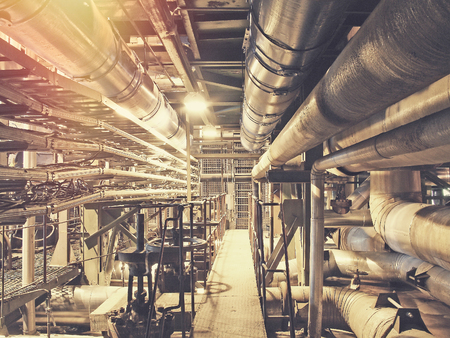 Equipment, cables and piping as found inside of a modern industrial power plant