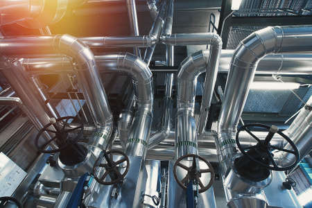 Equipment, cables and piping as found inside of a modern industrial power plant