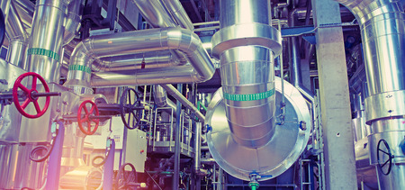 Equipment, cables and piping as found inside of a modern industrial power plant       