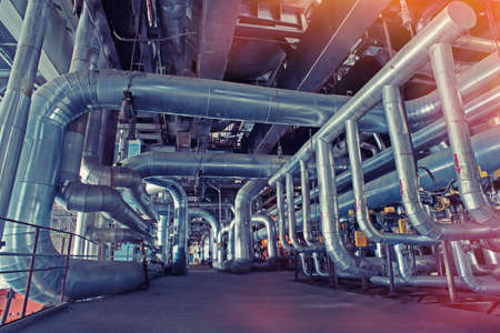 Equipment, cables and piping as found inside of a modern industrial power plant          