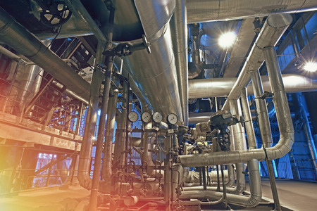 Equipment, cables and piping as found inside of a modern industrial power plant