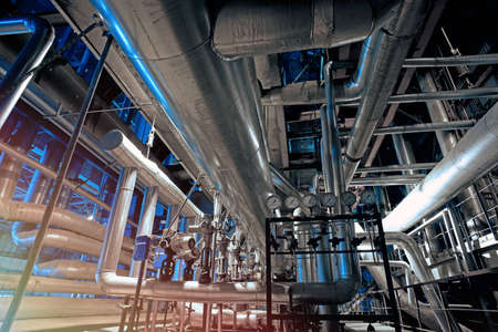 Equipment, cables and piping as found inside of a modern industrial power plant                   