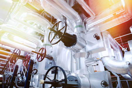 Equipment, cables and piping as found inside of a old industrial power plant