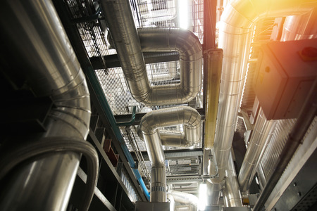 Equipment, cables and piping as found inside of a modern industrial power plant                    ...
