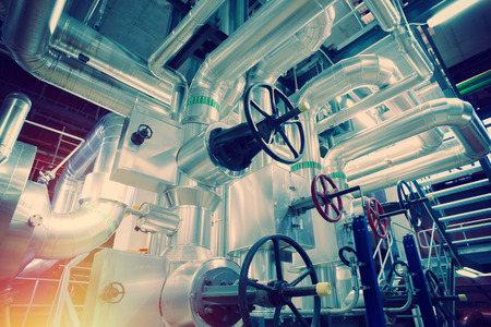 Equipment, cables and piping as found inside of a old industrial power plantの写真素材