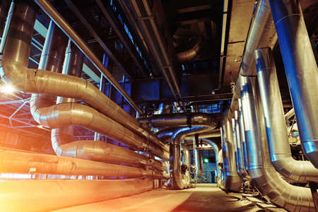 Equipment, cables and piping as found inside of a modern industrial power plant           
