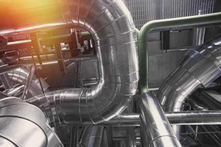 Equipment, cables and piping as found inside of a modern industrial power plant        