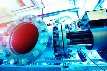 different size and shaped pipes and valves at a power plant の写真素材