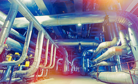 Equipment, cables and piping as found inside of a modern industrial power plant                 