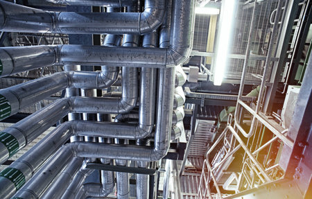 Equipment, cables and piping as found inside of a modern industrial power plant               