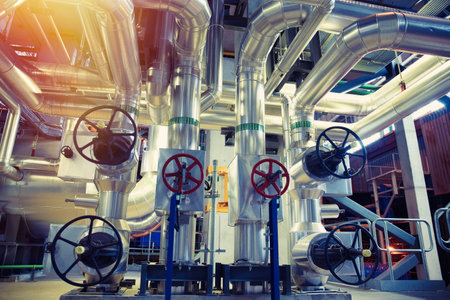 Equipment, cables and piping as found inside of a modern industrial power plant               