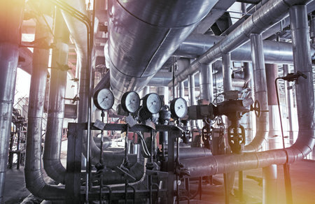 Equipment, cables and piping as found inside of a modern industrial power plant    
