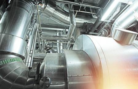 Equipment, cables and piping as found inside of a modern industrial power plant           